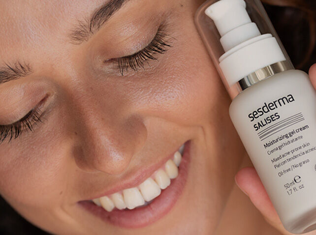 Imagen categoría acné con una mujer sonriendo sosteniendo un producto Salises